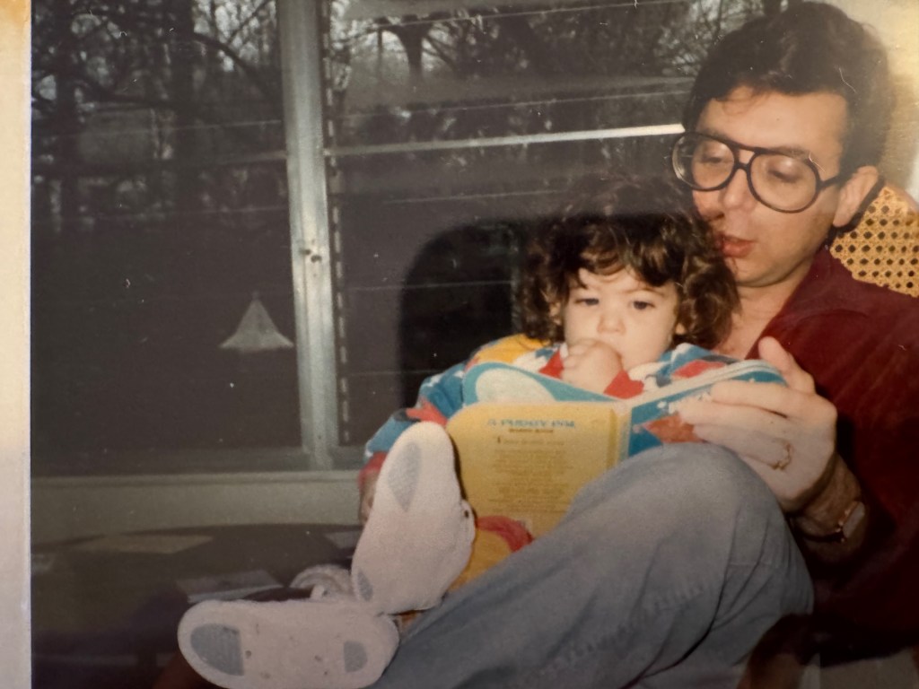 Little Audrey Barbakoff with her dad listening to a book